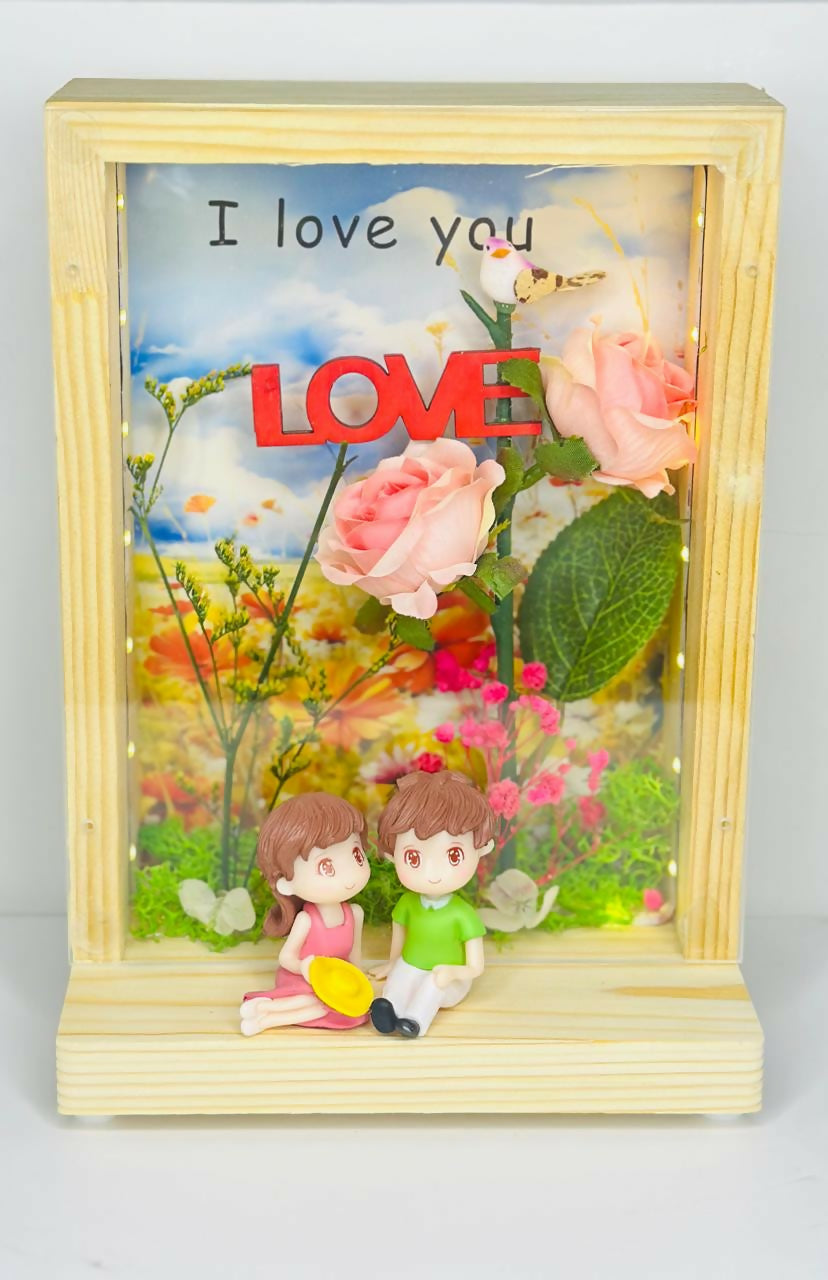 Love-Themed LED Wooden Display Case with Pink Rose Bouquet and Boy-Girl Figurines photo frame – Elegant Night Light and Sentimental Gift for Couples