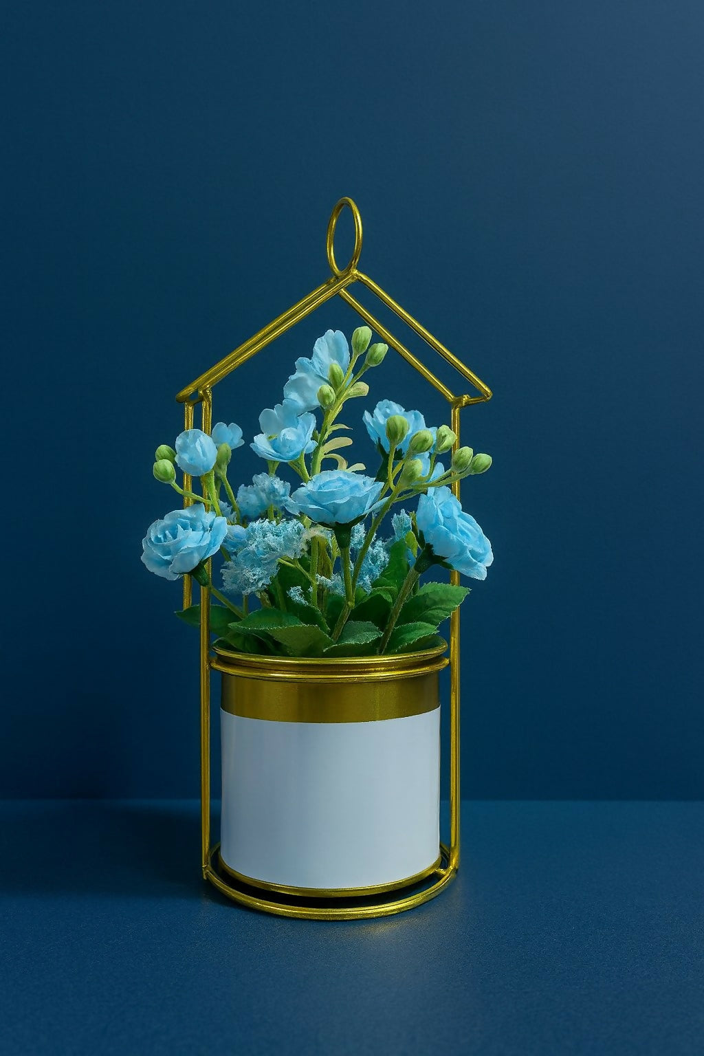 Golden Metal House-Shaped Stand with Artificial Blue Roses and Fillers in Glossy White Pot – Elegant Decorative Flower Arrangement for Home, Office & Gift