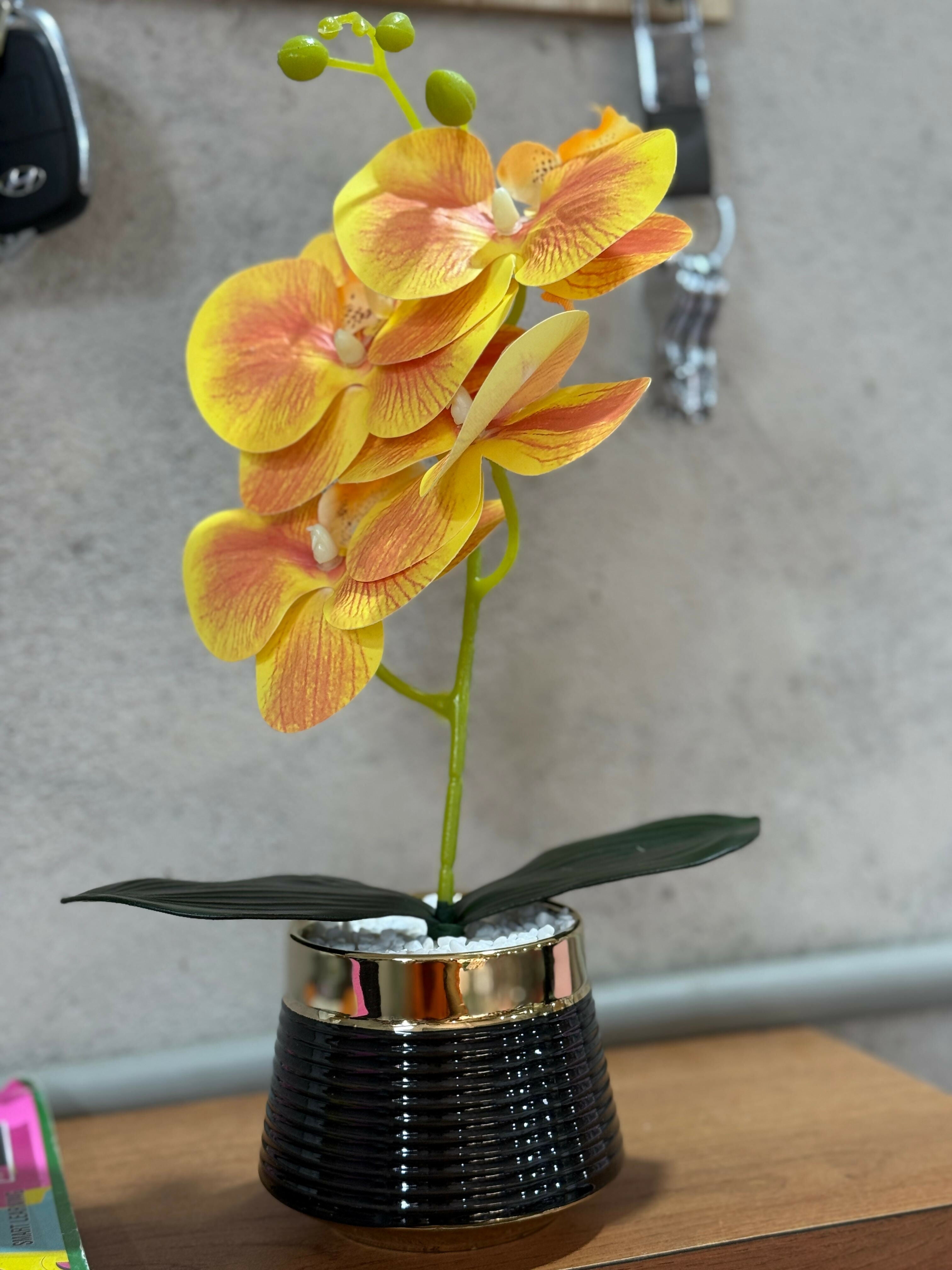 Premium Artificial Yellow Orange Orchid Flower Plant in Glossy Black Ceramic Pot – Decorative Faux Orchid with White Pebbles for Home, Office, Living Room & Gifting