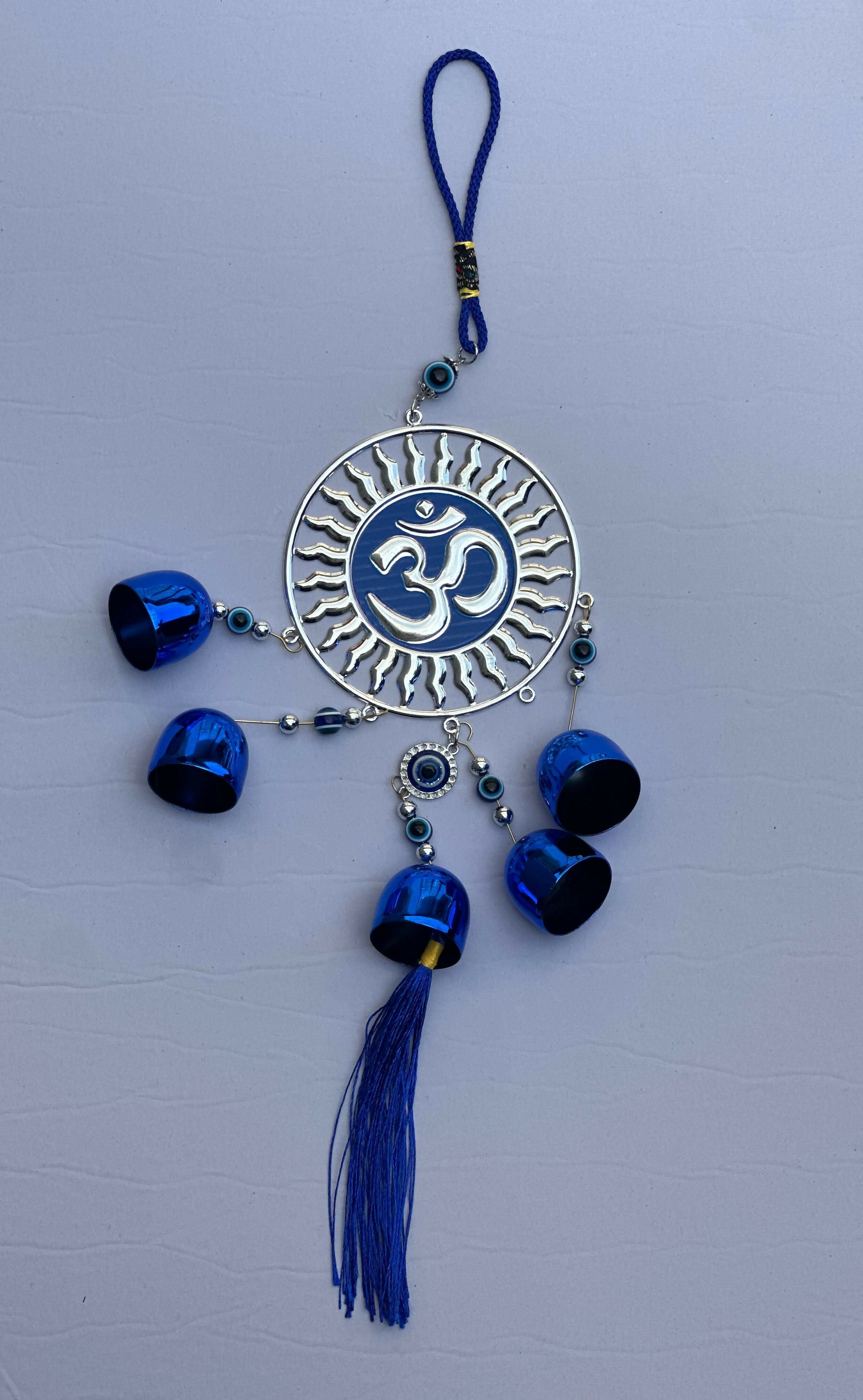 Spiritual Om Wall Hanging with Sun Design and Evil Eye Charms – Blue Metal Decorative Bell Wind Chime with Tassels for Positive Energy, Protection, and Home Vastu – Ideal for Home, Office, Balcony, or Gift Use