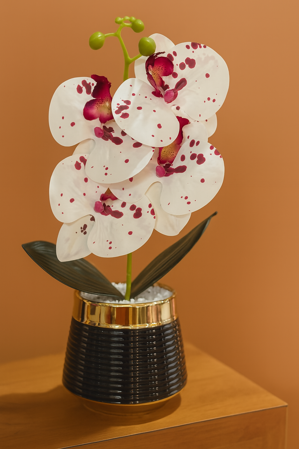 Premium Artificial Spotted White Orchid Flower Plant in Glossy Black Ceramic Pot – Faux Orchid with Red Accents and White Pebbles for Home, Office, Tabletop & Gifting