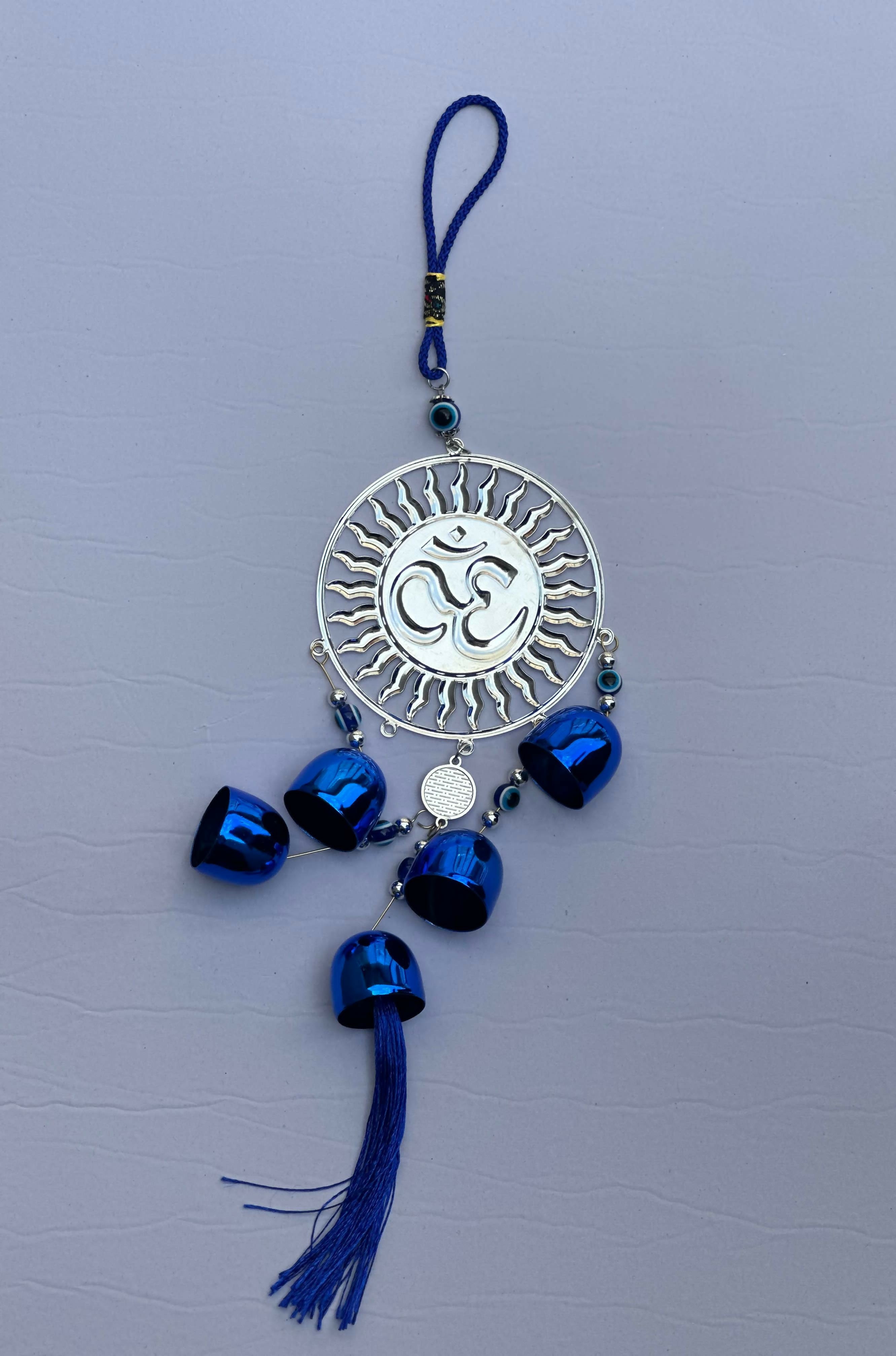 Spiritual Om Wall Hanging with Sun Design and Evil Eye Charms – Blue Metal Decorative Bell Wind Chime with Tassels for Positive Energy, Protection, and Home Vastu – Ideal for Home, Office, Balcony, or Gift Use