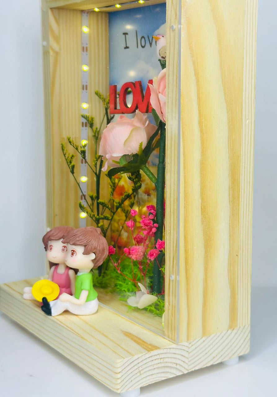 Love-Themed LED Wooden Display Case with Pink Rose Bouquet and Boy-Girl Figurines photo frame – Elegant Night Light and Sentimental Gift for Couples