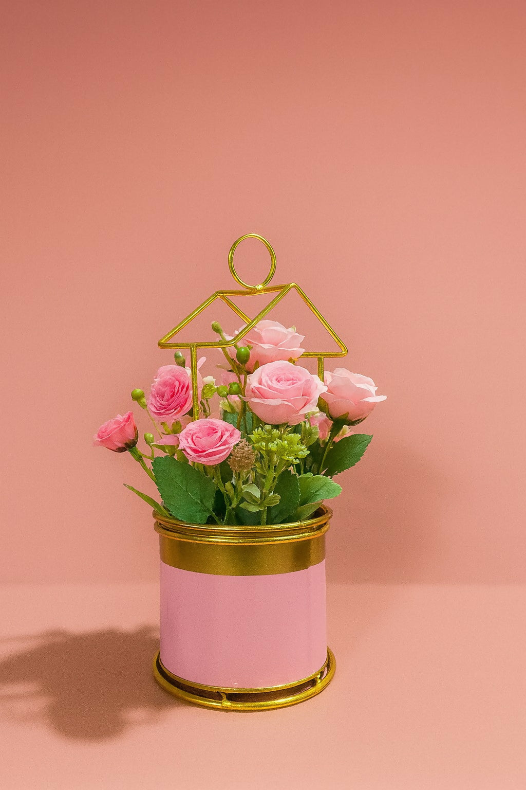 Golden Metal Frame House-Shaped Stand with Artificial Pink Roses in Glossy Pink Pot – Decorative Flower Arrangement for Home, Office, and Gift Use